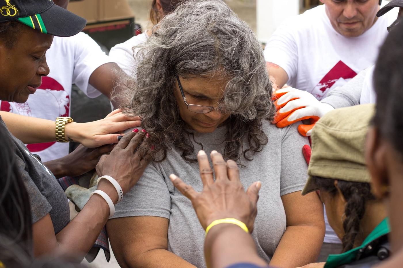 Members of Oasis Church praying together